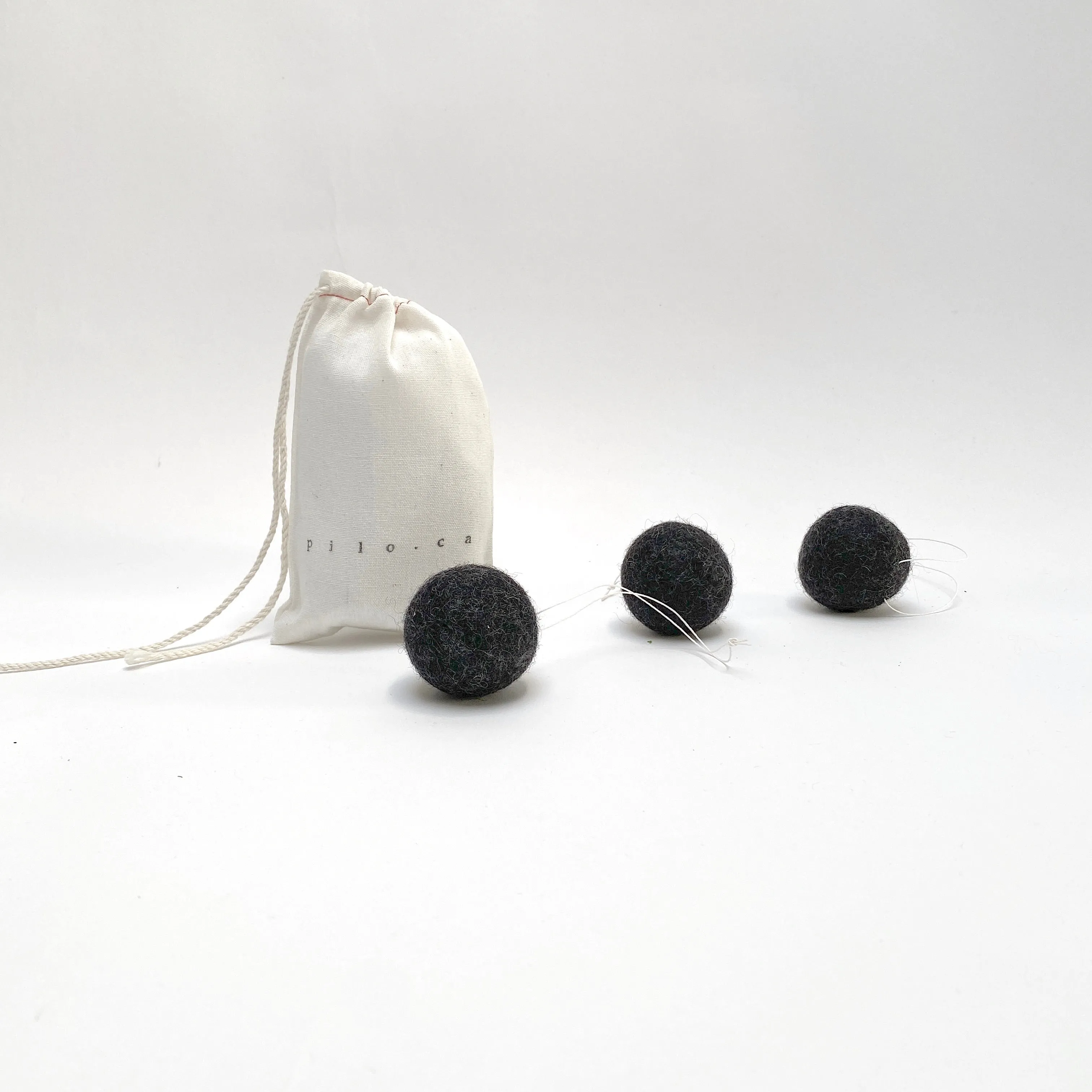 felted wool balls (in cotton bag)