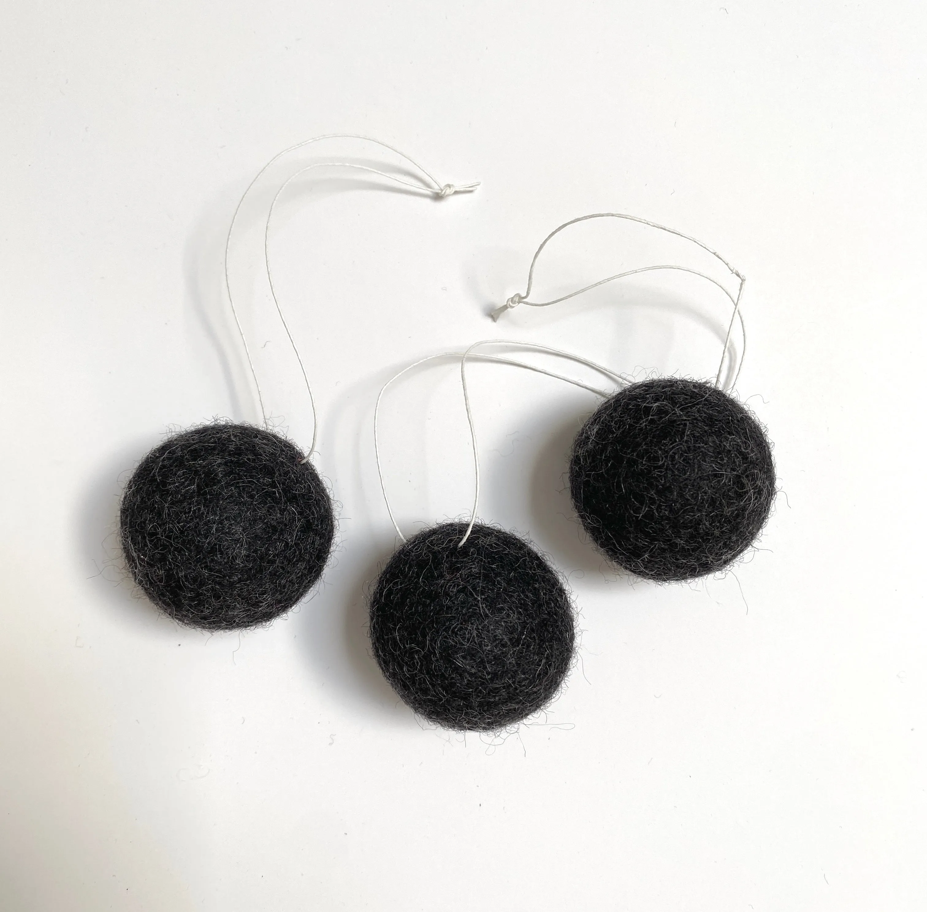 felted wool balls (in cotton bag)