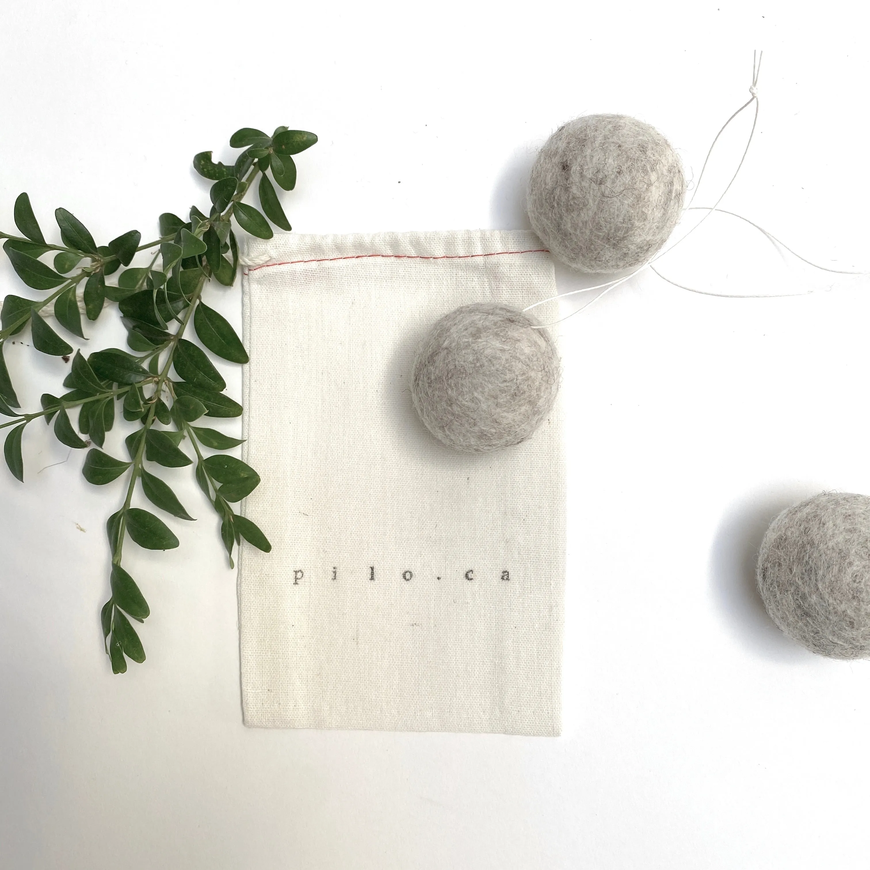 felted wool balls (in cotton bag)